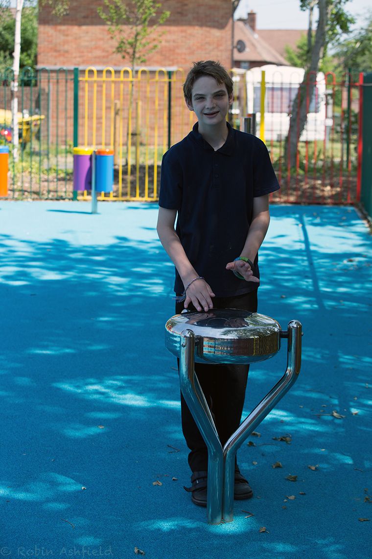 Boy Playing Stainless Steel Tongue Drum in Playground