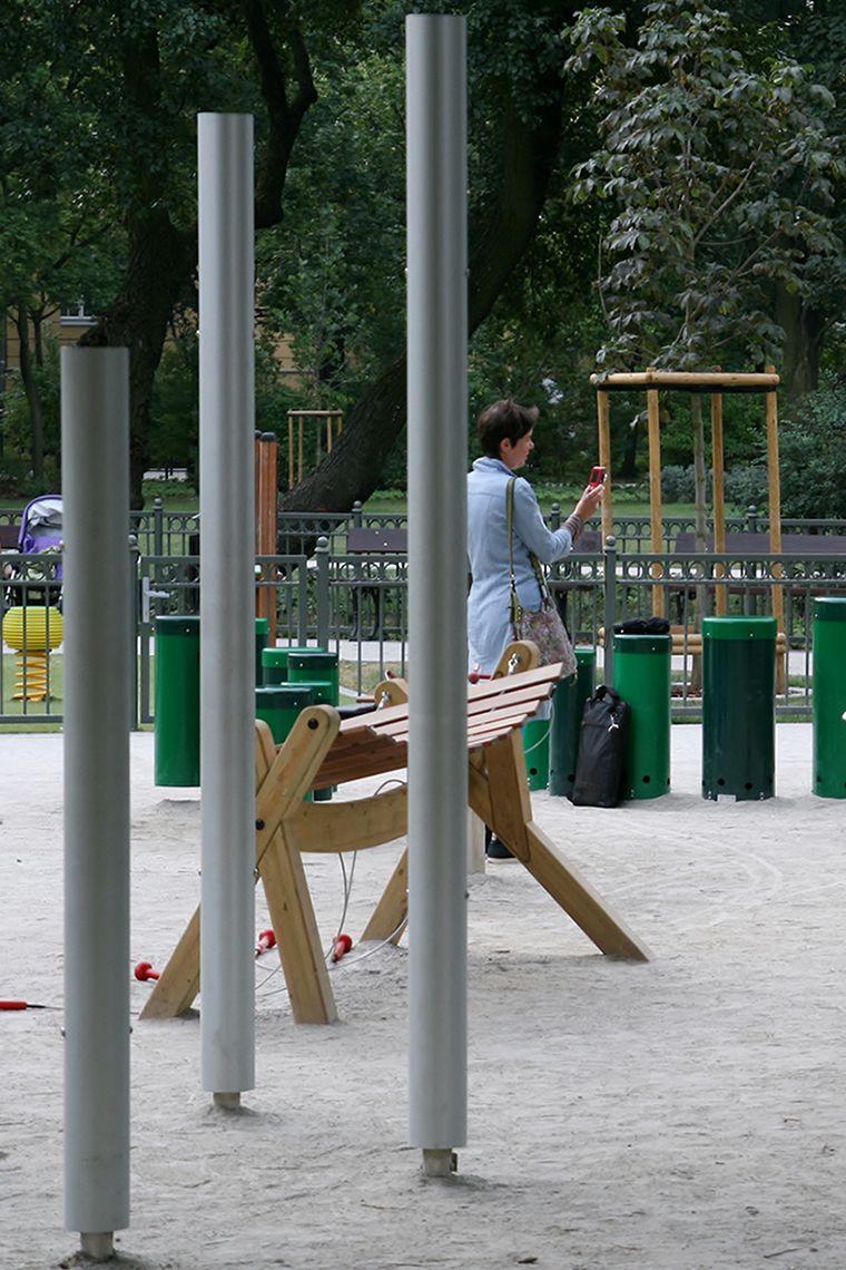 Three silver chimes installed in a children's playground