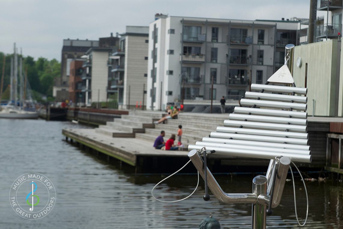 large metal outdoor xylophone on quayside setting